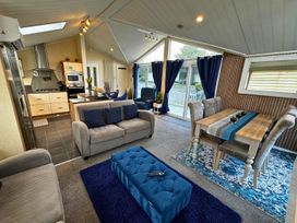 A living room and kitchen area with furniture at Sunset 5 Southview Holiday Park Skegness