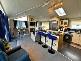 A living room with dining area and kitchen at Sunset 5 Southview Holiday Park Skegness