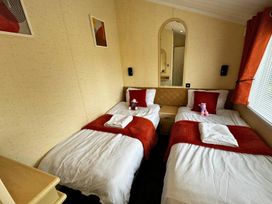 A bedroom with two single beds at Sunset 5 Southview Holiday Park Skegness