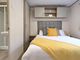 A bedroom with a bed and shelf at The Old Barn in Manchester