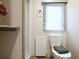 A bathroom with a shower and toilet at 