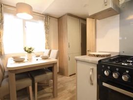 A kitchen with table and chairs at the property