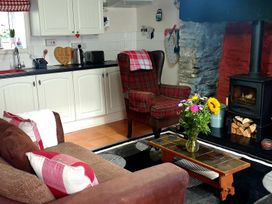 A living room with a fireplace and seating area at the property in the location