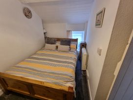 A bedroom with a bed and bedside table at The Old Barn in Manchester