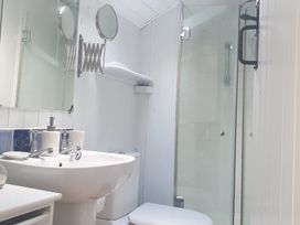 A bathroom with a sink, toilet, and shower at The Old Barn in Manchester