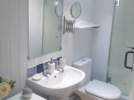 A bathroom with a sink, toilet and shower at The Old Barn in Manchester