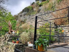 A garden with stone wall and plants at the property