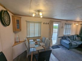 A dining room with a table and chairs at a property in an unknown location