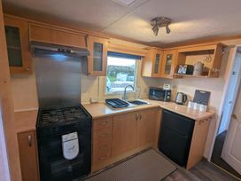 A kitchen with a stove and sink at a property