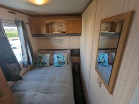 A bedroom with a bed and pillows at 