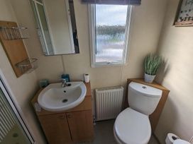 A bathroom with a sink and toilet at 