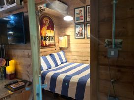 A bedroom with a bed and television at The Old Barn in Manchester