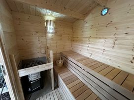 A sauna with wooden benches and a stove at 