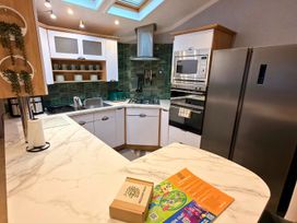 A kitchen with cabinets, sink, stove, and refrigerator at the property in the unspecified location