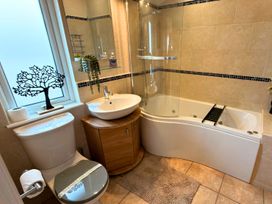 A bathroom with a bathtub, sink, and toilet at 