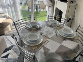 A dining table set with plates and glasses at a property