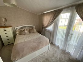 A bedroom with a bed and dresser at The Old Barn in Manchester