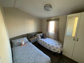 A bedroom with two beds and a wardrobe at 