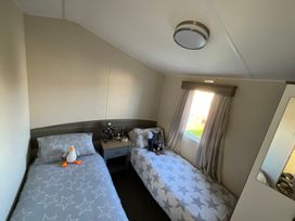 A bedroom with two beds and toys at unspecified property