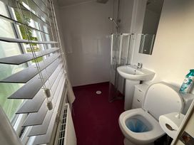 A bathroom with a shower, sink, and toilet at the property.