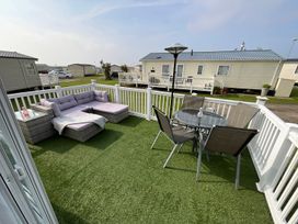 An outdoor patio with a couch and dining table at the property in unspecified location
