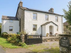 A house with a front pathway and gate at Three Mile House in Carnforth