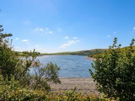 A view of a river surrounded by hills and trees at Three Mile House in Carnforth