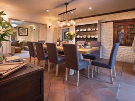 A dining room with a table and chairs at Three Mile House in Carnforth