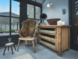 A snug with a chair and table at Three Mile House in Carnforth
