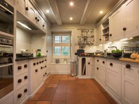 A kitchen with cabinets, countertop, and appliances at Three Mile House in Carnforth