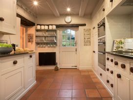 A kitchen with cabinets and appliances at Three Mile House in Carnforth