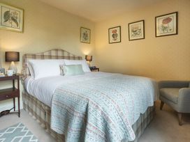 A bedroom with a bed and nightstand at Three Mile House in Carnforth