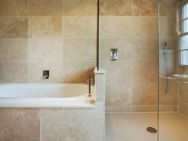 A bathroom with a bathtub and shower at Three Mile House in Carnforth
