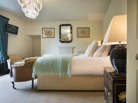 A bedroom with a bed and a couch at Three Mile House in Carnforth
