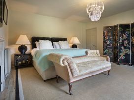 A bedroom with a bed and a sofa at Three Mile House in Carnforth