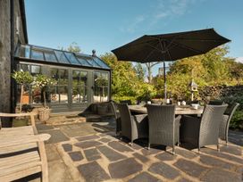 An outdoor dining area with a table and chairs at Three Mile House in Carnforth