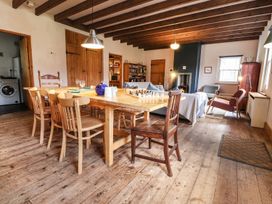 A dining room with a table and chairs at Llys Gwaun in Fishguard