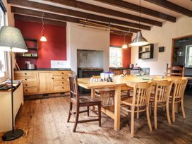 A kitchen with a table and chairs at Llys Gwaun in Fishguard