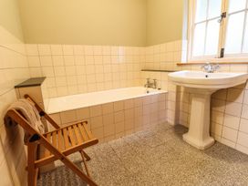 A bathroom with a bath tub and wash basin at Llys Gwaun Fishguard