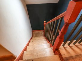 A staircase with wooden steps and a handrail at Llys Gwaun in Fishguard
