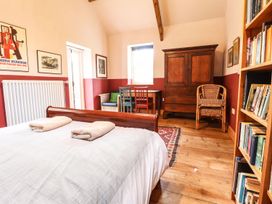 A bedroom with a bed and bookshelf at Llys Gwaun Fishguard