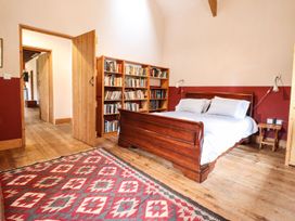 A bedroom with a bed and bookshelf at Llys Gwaun in Fishguard