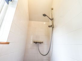 A shower with a shower head and valve at Llys Gwaun in Fishguard
