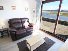 A living room with a sofa and a coffee table at Aldena South Snowdon Wharf in Porthmadog
