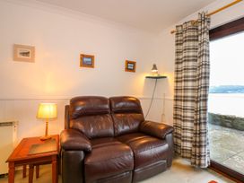 A living room with a sofa and lamp at Aldena South Snowdon Wharf Porthmadog
