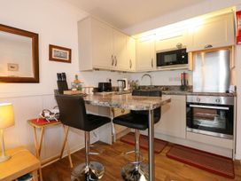 A kitchen with appliances and furniture at Aldena South Snowdon Wharf Porthmadog