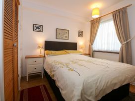A bedroom with a bed and bedside table at Aldena South Snowdon Wharf in Porthmadog