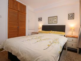 A bedroom with a bed and wardrobe at Aldena South Snowdon Wharf Porthmadog