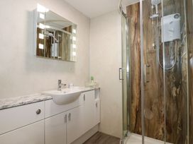 A bathroom with a sink and shower at Aldena South Snowdon Wharf in Porthmadog