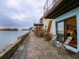 An outdoor area with a pathway alongside a river at Aldena South Snowdon Wharf in Porthmadog